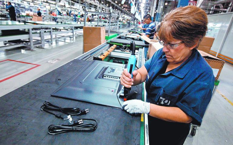 FILE PHOTO: An employee works at an LED TV assembly line at a factory that exports to the U.S. in Ciudad Juarez