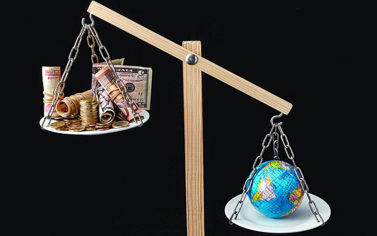 Globe,Planet,Earth,And,Money,On,A,Two,Pan,Balance