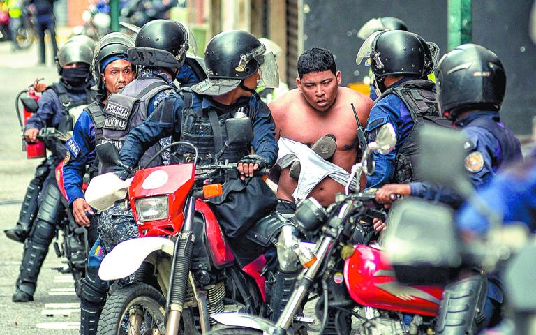 Miembros de la guardia detuvieron a un hombre en una protesta del 30 de julio. Foto: AFP