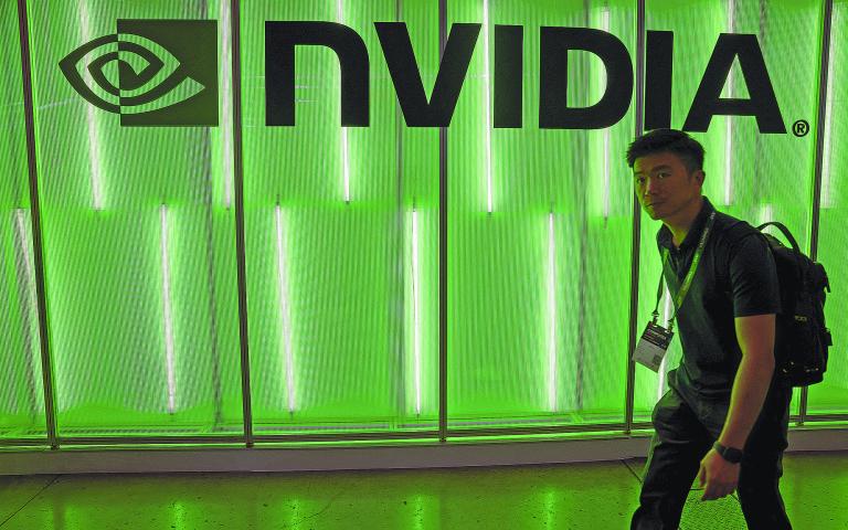 FILE PHOTO: A person walks pass a Nvidia logo at Computex in Taipei, Taiwan June 5, 2024. REUTERS/Ann Wang/File Photo-NARCH/NARCH30