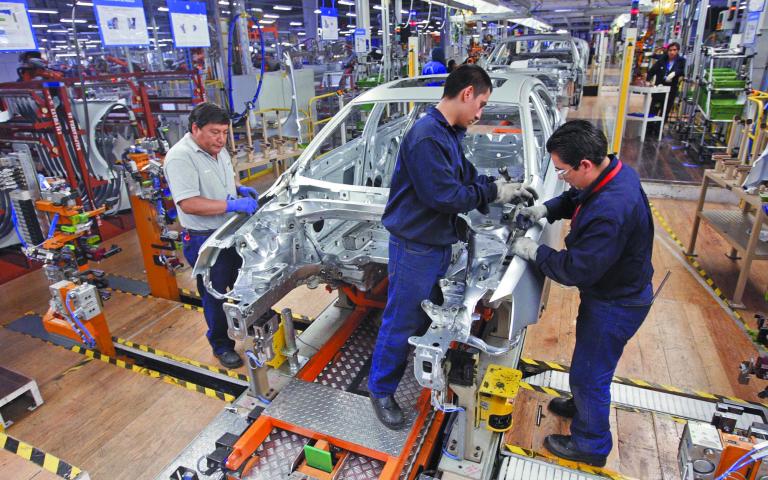 Employees work on the assembly line on the Jetta Bicentennial at the Volkswagen automobile manufacturing factory in Puebla