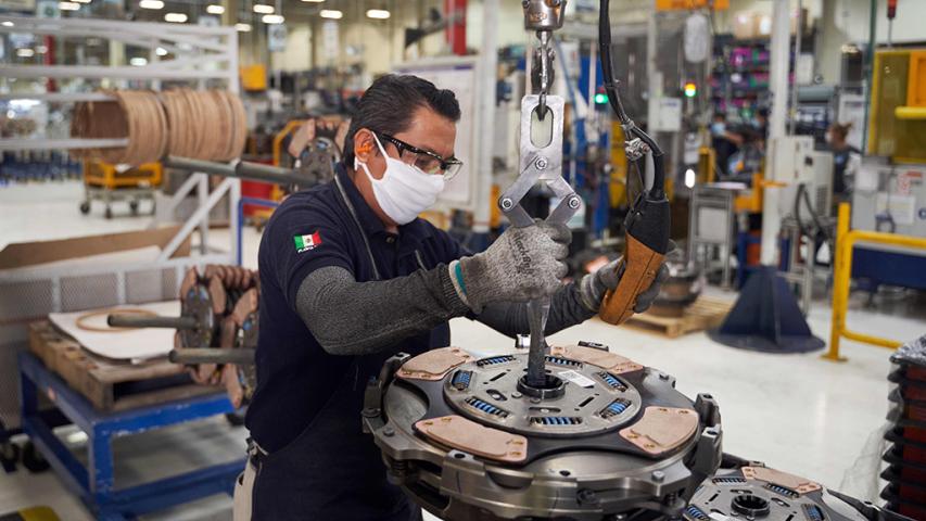 A worker resumes activities at a truck part factory after it was closed for several weeks to prevent the spread of coronavirus in San Luis Potosi, Mexico on May 27, 2020. (Photo by MAURICIO PALOS / AFP)