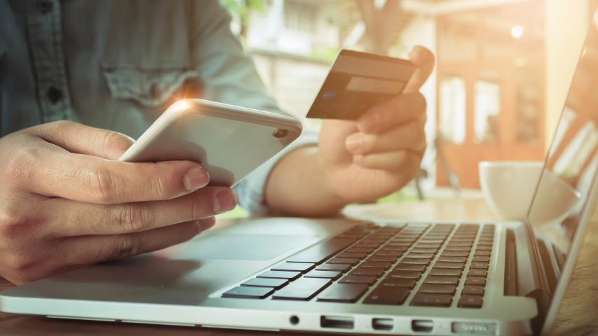 Online payment,Man's hands holding smartphone  and using credit card for online shopping.