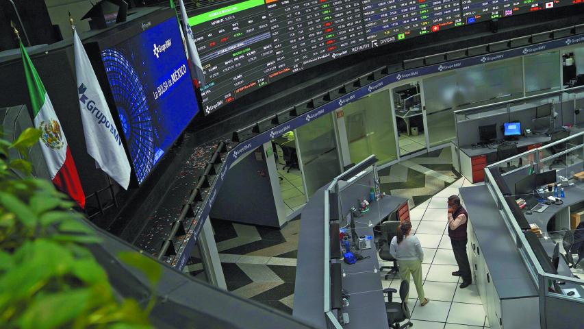 Employees interact as a ticker displays stock exchange data at Mexico's stock exchange, in Mexico City, Mexico June 1, 2021. REUTERS/Toya Sardo Jordan