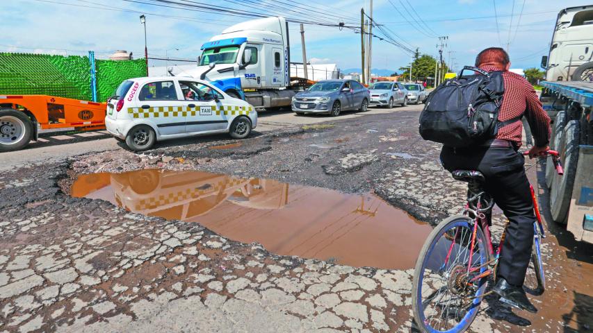 TOLUCA, ESTADO DE MÉXICO, 08AGOSTO2024.-  Automovilistas evitan los baches que se encuentran en la avenida Industria Automotriz en la ciudad de Toluca, que con el paso de vehículos pesados y las lluvias se hacen más grandes. FOTO: CRISANTA ESPINOSA AGUILAR /CUARTOSCURO.COM