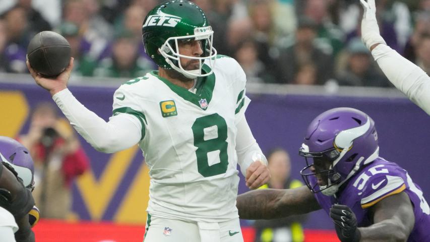 Oct 6, 2024; London, United Kingdom; New York Jets quarterback Aaron Rodgers (8) throws the ball under pressure from Minnesota Vikings center Garrett Bradbury (56) in the second half at Tottenham Hotspur Stadium. Mandatory Credit: Kirby Lee-Imagn Images