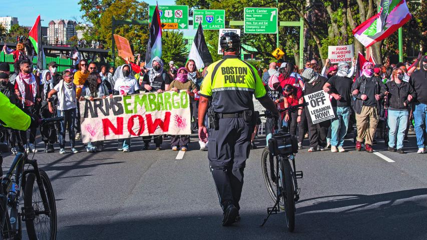 Police look on as pro-Palestinian demonstrators march during a rally to mark one year of the war between Hamas and Israel in Boston, Massachusetts on October 6, 2024. (Photo by Joseph Prezioso / AFP)