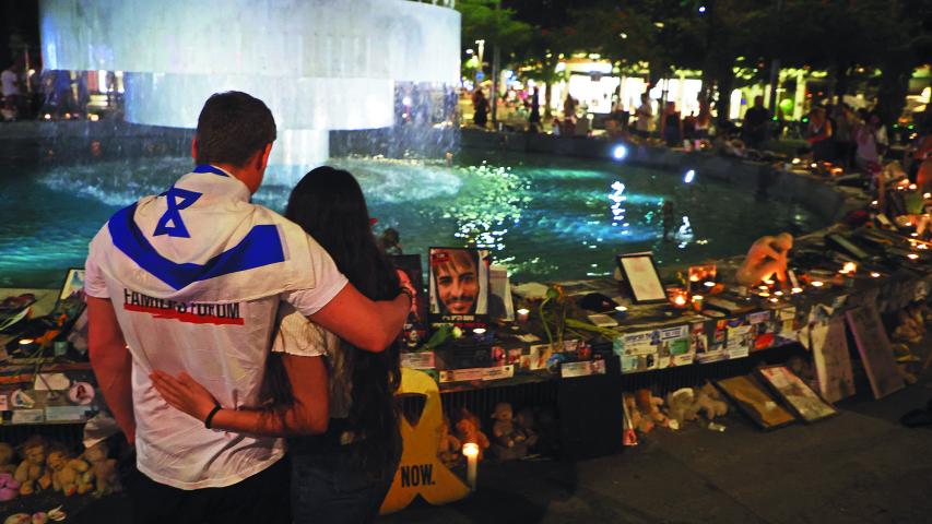 People gather to mark the first anniversary of the October 7, 2023 attacks, in the Israeli coastal city of Tel Aviv on October 7, 2024. - Israel marked the first anniversary of the deadliest attack in its history, with Prime Minister Benjamin Netanyahu saying the Gaza and Lebanon wars would ensure the violence it endured last October 7 could never be repeated. (Photo by GIL COHEN-MAGEN / AFP)