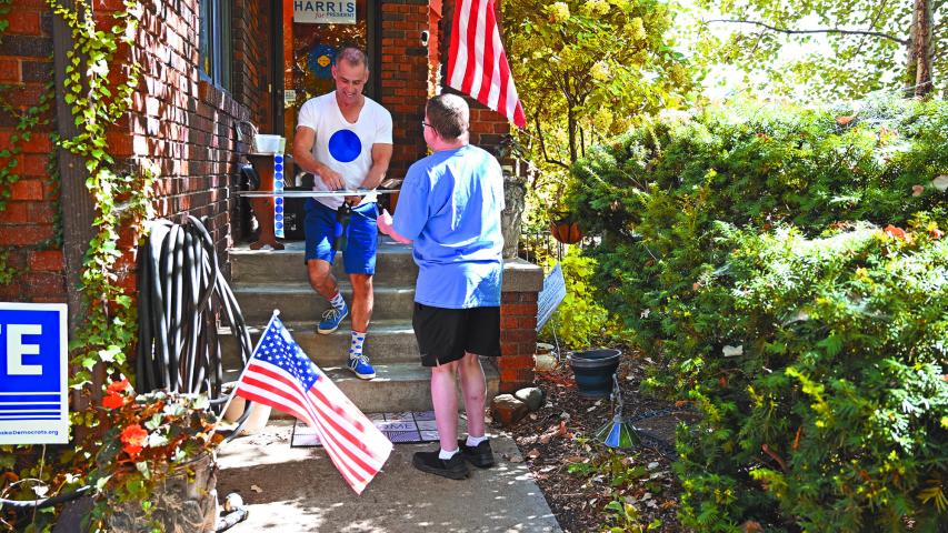 Jason Brown gives a neighbor a handcrafted political sign featuring a simple blue dot, at his home in Omaha, Nebraska, on September 30, 2024. - Nestled deep in America's heartland, Nebraska is best known for corn, cattle and college football -- not usually for its elections. That could be about to dramatically change.
A strange quirk of the devoutly Republican state's constitution essentially gives Omaha -- the largest city -- its own distinct and powerful vote for the next US president, in a race that remains too close to call just one month out.
In the far-from-impossible scenario that Kamala Harris and Donald Trump are otherwise tied in the Electoral College that determines the White House's next occupant, this tiny Democratic-leaning "blue dot" of 650,000 people could have the final say. (Photo by Alex WROBLEWSKI / AFP)