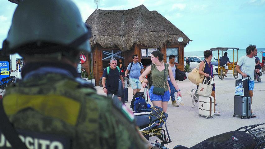 A member of the Mexican Army watches while residents and tourists heed a voluntary evacuation call as Hurricane Milton advances, on the island of Holbox, Mexico, October 7, 2024. REUTERS/Paola Chiomante