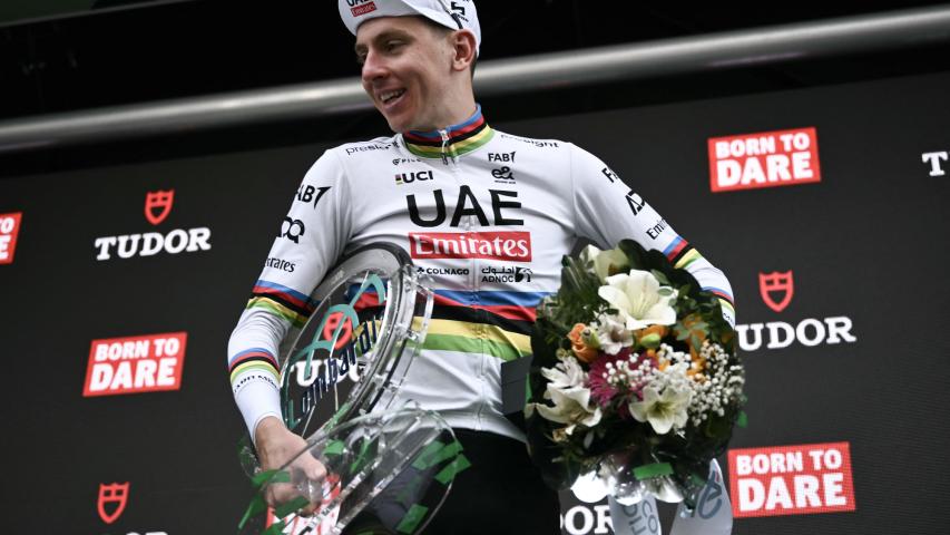 UAE Team Emirates team's Slovenian rider Tadej Pogacar celebrates his victory with the trophy on the podium after winning the 118th edition of the Giro di Lombardia (Tour of Lombardy), a 252km cycling race from Bergamo to Como on October 12, 2024. (Photo by Marco BERTORELLO / AFP)