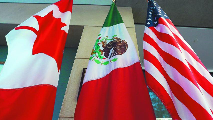 (FILES) This file photo taken on September 24, 2017 shows the Mexican, US and  Canadian flags in the lobby where the third round of the NAFTA renegotiations took place in Ottawa, Ontario.
Canada announced on January 23, 2018 it will sign on the Trans Pacific Partnership, moving to diversify its trade relationships  as Canadian, US and Mexican negotiators kicked off a sixth round of talks on a 1994 free trade pact that Washington has threatened to dump. Canada had initially balked at joining the proposed TPP last year, acting as the main holdout in negotiations after US President Donald Trump decided in early 2017 to go it alone under his "America First" policy.
 / AFP PHOTO / Lars Hagberg