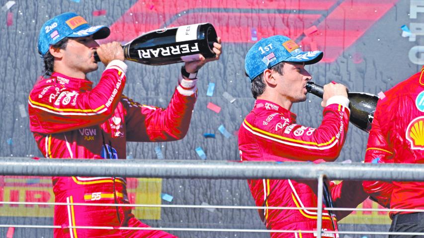 Oct 20, 2024; Austin, Texas, USA; Scuderia Ferrari driver Carlos Sainz (left) of Team Spain and Scuderia Ferrari driver Charles Leclerc (right) of Team Monaco drink champagne on the podium after the 2024 Formula One US Grand Prix at Circuit of the Americas. Mandatory Credit: Jerome Miron-Imagn Images