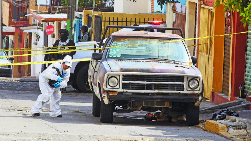 A forensic technician approaches a crime scene where several people died when armed assailants attacked a group of people gathered in the street, in Cuernavaca, Mexico November 20, 2023. REUTERS/Margarito Perez Retana