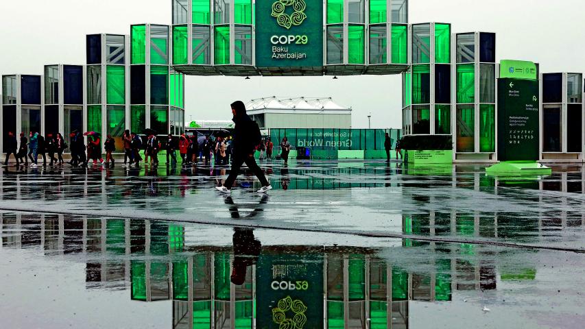 People walk at the entrance of the venue of the United Nations climate change conference COP29, in Baku, Azerbaijan November 18, 2024. REUTERS/Murad Sezer