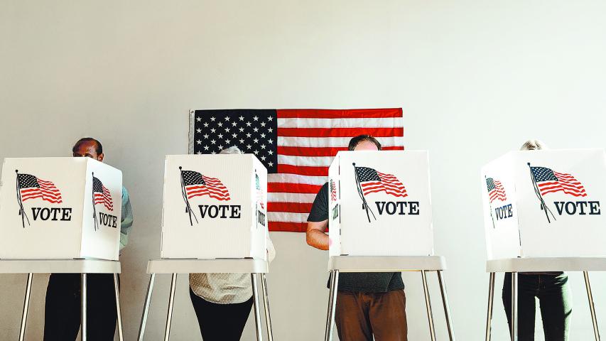 US election day, Diverse people at voting booth at US election station with American flag in background. Diverse people in line to vote at US election day. Vote for American democracy.