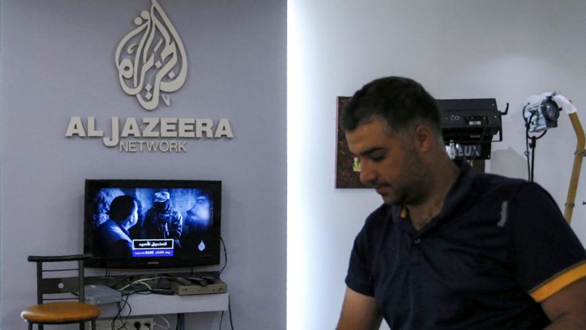 (FILES) An employee of the Qatar based news network and TV channel Al-Jazeera is seen at the channel's Jerusalem office on July 31, 2017. - The Palestinian Authority on January 1, 2025 ordered the suspension of broadcasts by the Qatar-based Al Jazeera across the Palestinian territories, accusing the network of airing "inciting content," official media reported. (Photo by AHMAD GHARABLI / AFP)