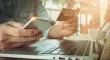 Online payment,Man's hands holding smartphone  and using credit card for online shopping.