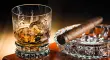 Whiskey and cigar on wooden box close u