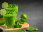two glasses of aloe vera  juice put on wooden cutting board