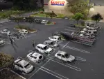 Aerial view of burned cars in the parking lot of a Costco retail store in Puerto Vallarta, Jalisco state, Mexico, on February 23, 2026. Mexico has deployed 10,000 troops to quell clashes sparked by the killing of the country's most wanted drug lord, which have left dozens dead, officials said on February 23. Nemesio 