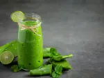 a glass of aloe vera  juice put on dark floor