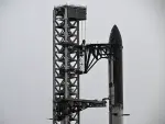 SpaceX's new Starship V3 rocket is seen docked at the Starbase during the 12th test flight on May 21, 2026 as seen from South Padre Island in Texas. Elon Musk's SpaceX is set for the debut launch of its latest Starship iteration on Thursday, testing the most powerful version yet of the megarocket as the company targets a blockbuster initial public offering. (Photo by RONALDO SCHEMIDT / AFP)