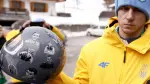 Ukraine's skeleton racer Vladyslav Heraskevych holds his helmet, which depicts victims of his country's war with Russia, in Cortina d'Ampezzo on February 12, 2026. Heraskevych was disqualified from the Winter Olympics on February 12, 2026 after refusing to back down over his banned helmet, which depicts victims of his country's war with Russia.The International Olympic Committee said he had been kicked out of the Milan-Cortina Games "after refusing to adhere to the IOC athlete expression guidelines". (Photo by Odd ANDERSEN / AFP)