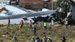 Rescue teams, military personnel, and forensic officers work at the site of the crash of the Bolivian Air Force Lockheed C-130 plane (FAB-81) in El Alto, near La Paz, on February 28, 2026. At least 20 people died on February 27 in a military plane crash in Bolivia that was carrying cash and crashed while landing at El Alto Airport, near La Paz, authorities reported. (Photo by AIZAR RALDES / AFP)