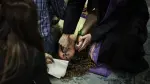 Self-proclaimed priest, not recognized by the Catholic Church, Francisco Marques, 27 years old, places his hands on a womans forehead as she lies on the floor, during a "exorcist retreat" where he claims to cast out demons afflicting his followers, organized by the "Prelature of Saints Peter and Paul in Fatima on May 30, 2026. The scene unfolds not in a church but in the basement of a small shopping centre a short walk from the vast esplanade of Portugal's famed Fatima shine, one of the Catholic Church's most visited pilgrimage sites.The gathering was part of a series of monthly "exorcism retreats" held in Fatima that have raised concerns among Catholic authorities, who say they operate outside official Church oversight by self-styled religious figures and risk exploiting vulnerable believers. (Photo by PATRICIA DE MELO MOREIRA / AFP)
