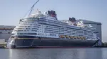 The new Disney Treasure cruise ship of Disney Cruise line is moored at the Meyer shipyards in Papenburg, northwestern Germany on September 16, 2024. At the company meeting, the employees were informed that the troubled luxury shipbuilder had been saved by the intervention of the Federal Republic of Germany and the state of Lower Saxony. (Photo by Focke STRANGMANN / AFP)