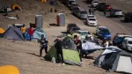 Workers from the Escondida copper mine set camp tents during a strike after failing to reach a labor agreement with Australian group BHP, in Puerto Coloso, Antofagasta, Chile, on August 14, 2024. Workers at the world's largest copper mine in Chile are striking after pay talks fell apart, casting a shadow of uncertainty over the market for the commodity as the Escondida mine digs up around five percent of the world's copper, a coveted metal used in everything from electrical wiring to rechargeable batteries. (Photo by SEBASTIAN ROJAS ROJO / AFP)