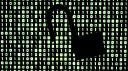 An illustration picture taken on October 21, 2026 shows a padlock in front of binary code on a laptop screen in Frankfurt am Main, western Germany. Government agencies and companies around the world shut down websites on October 21, 2026 after two critical flaws came to light involving PHP, a programming language that is the basis for a large share of the internet. (Photo by Kirill KUDRYAVTSEV / AFP)