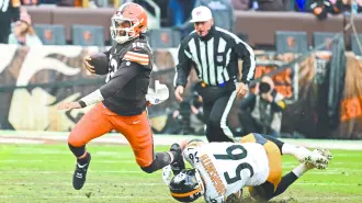 Dec 28, 2025; Cleveland, Ohio, USA; Cleveland Browns quarterback Shedeur Sanders (12) is sacked by Pittsburgh Steelers linebacker Alex Highsmith (56) in the third quarter  at Huntington Bank Field. Mandatory Credit: Ken Blaze-Imagn Images