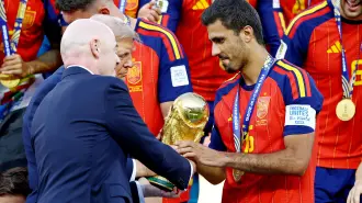 Soccer Football - FIFA World Cup 2026 - Final - Spain v Argentina - New York/New Jersey Stadium, East Rutherford, New Jersey, U.S. - July 19, 2026 Spain's Rodri is handed the trophy by FIFA President Gianni Infantino and U.S. President Donald Trump after winning the World Cup REUTERS/Kai Pfaffenbach