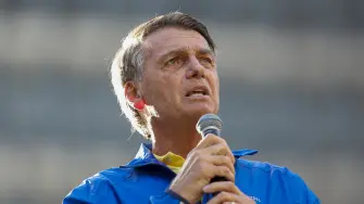 (FILES) Brazil's former President Jair Bolsonaro speaks during a rally on Paulista Avenue in Sao Paulo, Brazil, on June 29, 2025. Former Brazilian President Jair Bolsonaro, who is serving a 27-year prison sentence for an attempted coup, underwent medical treatment on December 27, 2025, for the hiccups he has been suffering from for months. (Photo by Miguel SCHINCARIOL / AFP)