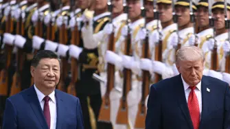 US President Donald Trump (R) and China's President Xi Jinping (L) inspect a guard of honour during a welcome ceremony at the Great Hall of the People in Beijing on May 14, 2026. (Photo by Brendan SMIALOWSKI / AFP)