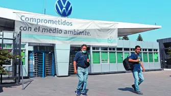 FILE PHOTO: Employees leave the Volkswagen (VW) plant as the company will temporarily close its factories in Mexico amid growing worries over the spread of the coronavirus disease (COVID-19), in Puebla