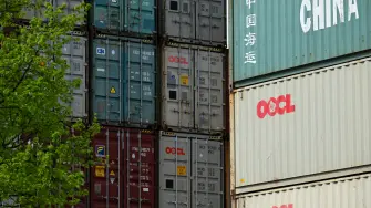 Containers of China Shipping and OOCL shipping companies are stacked at a transshipment station in Frankfurt am Main, western Germany, on April 15, 2025. German investor sentiment in April 2025 recorded its biggest fall since Russia's full-scale invasion of Ukraine, as US President Donald Trump's huge tariffs threatened to snuff out a recovery. Market expectations for Europe's biggest economy over the next six months fell 65.6 points to sit at minus 14, the largest drop since the outbreak of war in Ukraine in 2022, according to a survey by the ZEW institute. (Photo by Kirill KUDRYAVTSEV / AFP)