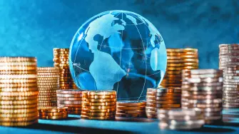 Globe and stack with coins. Money makes the world go round