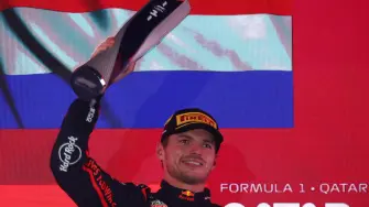 Formula One F1 - Qatar Grand Prix - Lusail International Circuit, Lusail, Qatar - November 30, 2025 Red Bull's Max Verstappen celebrates with a trophy on the podium after winning the Qatar Grand Prix REUTERS/Jakub Porzycki