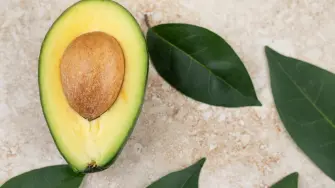 Sliced fresh delicious avocado on marble background. High quality photo