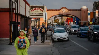 CHICAGO, ILLINOIS - OCTOBER 31: Families visit local businesses with children in costume to trick-or-treat and celebrate Halloween in the Little Village neighborhood on October 31, 2025, in Chicago, Illinois. Volunteers monitored the streets and storefronts as the celebration unfolded after Illinois Gov. J.B. Pritzker asked federal officials to pause immigration raids for the holiday weekend, a request rejected by U.S. Homeland Security Secretary Kristi Noem, who continued detainment missions across the Chicago area under President Donald Trump's administration's "Operation Midway Blitz." Little Village, a predominantly Mexican neighborhood and major cultural and commercial hub for Chicago's Latino community, held the event to help families enjoy the holiday despite heightened fears.   Jamie Kelter Davis/Getty Images/AFP (Photo by Jamie Kelter Davis / GETTY IMAGES NORTH AMERICA / Getty Images via AFP)