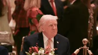 US President Donald Trump attends a Christmas dinner at his Mar-a-Lago resort in Palm Beach, Florida, on December 24, 2025. (Photo by ANDREW CABALLERO-REYNOLDS / AFP)