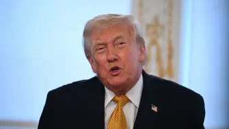 US President Donald Trump participates in calls to US service members, on Christmas Eve, from the Mar-a-Lago club in Palm Beach, Florida, December 24, 2025. (Photo by ANDREW CABALLERO-REYNOLDS / AFP)