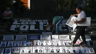 (FILES) Relatives of political prisoners take part in a demonstration called The table of those who wait, demanding their release, at Bolívar Square in the Chacao municipality of Caracas on December 14, 2025. At least 87 people detained in demonstrations following Nicolas Maduro's re-election in the 2024 presidential elections, which the opposition denounced as fraudulent, were released from prison on January 1, 2026 in Venezuela, according to two NGOs. (Photo by Federico PARRA / AFP)