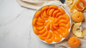 Peeled tangerines on marble background