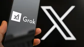 This photograph shows a smartphone bearing the logo of Grok, a generative artificial intelligence chatbot developed by US artificial intelligence company xAI in front of the X (formerly Twitter) logo in Brussels on January 12, 2026. (Photo by Nicolas TUCAT / AFP)
