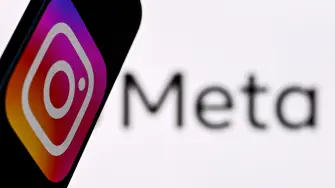 This photo illustration created on January 9, 2025, in Frankfurt am Main, western Germany, shows US social network Instagram logo displayed on a smartphone in front of the media giant Meta's logo on a laptop screen. Social media giant Meta on January 7, 2025 slashed its content moderation policies, including ending its US fact-checking program on Facebook and Instagram, in a major shift that conforms with the priorities of incoming president Donald Trump. The EU on January 8 rejected Meta chief Mark Zuckerberg's charge that the bloc engaged in "censorship" with its tech regulations. (Photo by Kirill KUDRYAVTSEV / AFP)