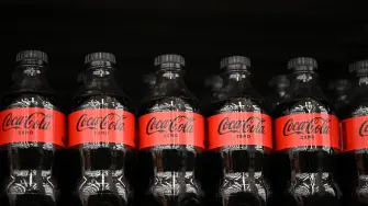 This view shows bottles of Coca-Cola Zero soda displayed for sale on shelves at a Walmart store in Mexico City on October 27, 2025. (Photo by Yuri CORTEZ / AFP)